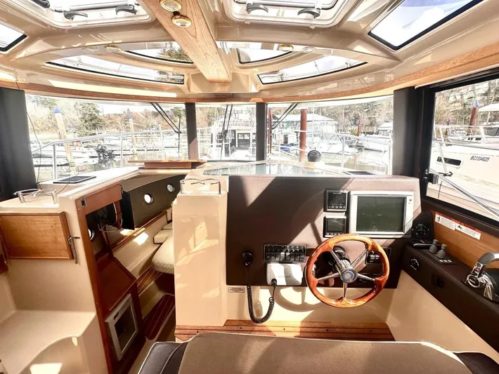  Yacht Photos Pics Interior of 2015 Ranger Tugs R-29S boat, featuring helm with steering wheel and navigation equipment.