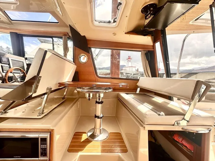  Yacht Photos Pics 2015 Ranger Tugs R-29S interior with seating, table, and windows.