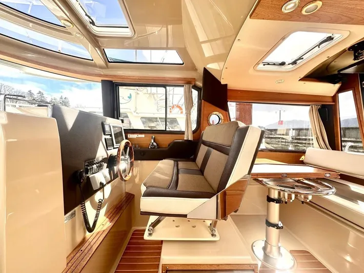  Yacht Photos Pics Interior of 2015 Ranger Tugs R-29S boat with helm, seating, and skylights.