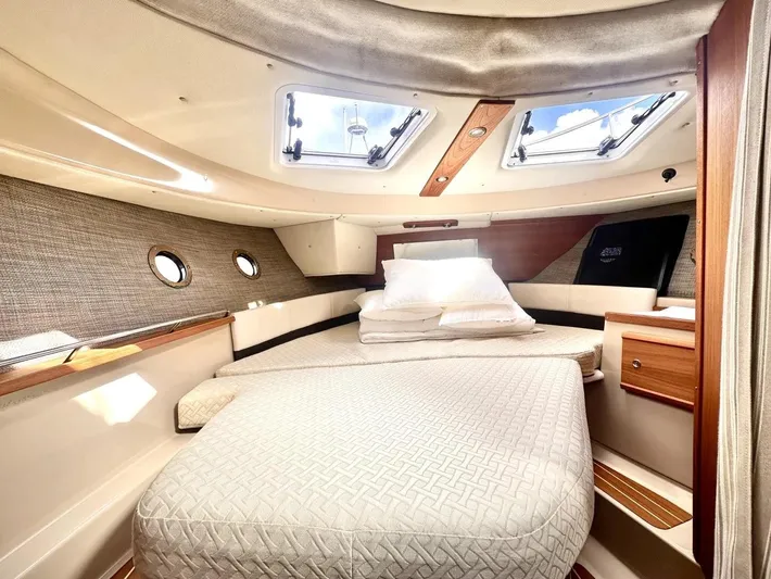  Yacht Photos Pics 2015 Ranger Tugs R-29S cabin interior with bed, portholes, and skylights.
