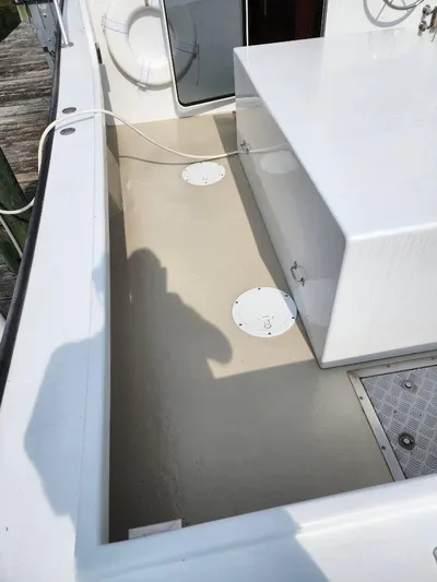  Yacht Photos Pics 2016 Custom Broad Creek 32 Downeast boat deck with storage compartments and clean white finish.