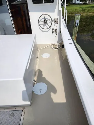  Yacht Photos Pics 2016 Custom Broad Creek 32 Downeast boat deck with steering wheel and clean layout.