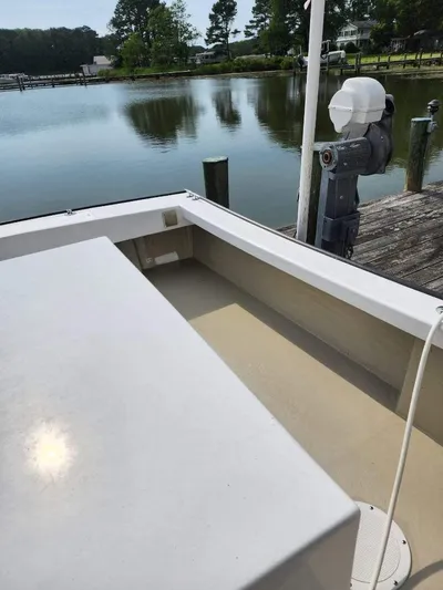  Yacht Photos Pics 2016 Custom Broad Creek 32 Downeast boat docked by a serene waterfront.