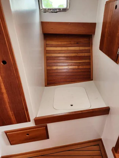  Yacht Photos Pics Interior of 2016 Custom Broad Creek 32 Downeast boat with wooden accents and storage compartments.