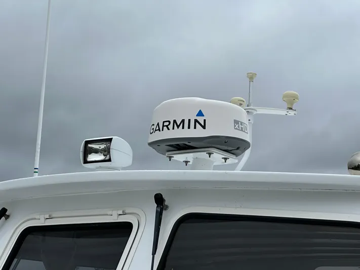  Yacht Photos Pics Garmin radar on 2016 Custom Broad Creek 32 Downeast boat against cloudy sky.