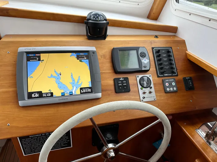 Yacht Photos Pics Helm of 2016 Custom Broad Creek 32 Downeast with navigation equipment and steering wheel.