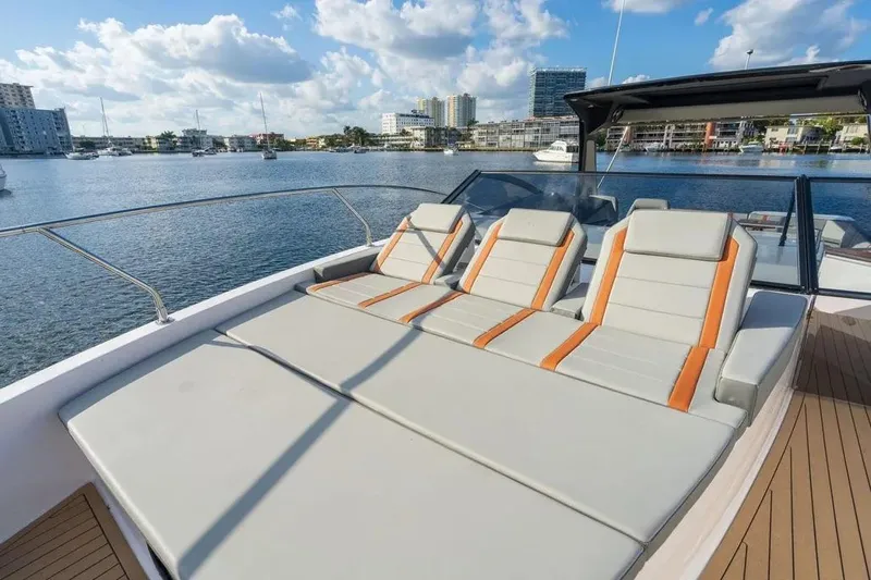  Yacht Photos Pics Luxurious 2025 Hanover 377 yacht with sun loungers on deck, overlooking a scenic marina.