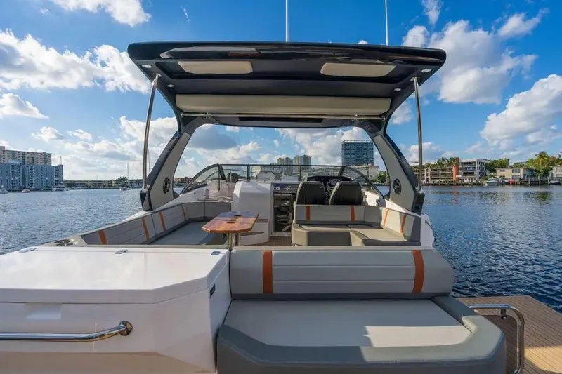  Yacht Photos Pics Luxurious 2025 Hanover 377 yacht interior with spacious seating, docked by a scenic waterfront.