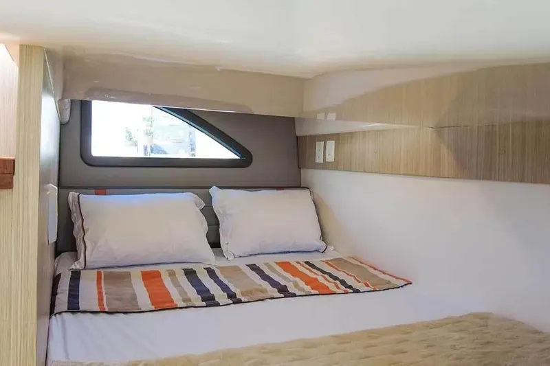  Yacht Photos Pics Compact bedroom interior in 2025 Hanover 377, featuring cozy bedding and modern design.