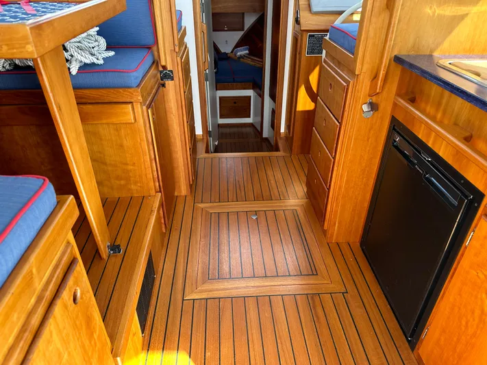  Yacht Photos Pics 2016 Custom Broad Creek 32 Downeast interior with wood flooring and compact kitchen area.