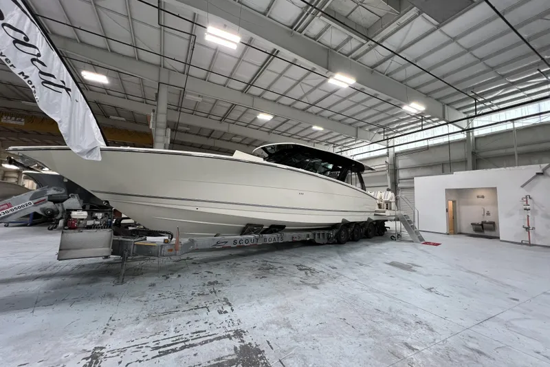  Yacht Photos Pics 2025 Scout 530 LXF boat in a spacious indoor facility.