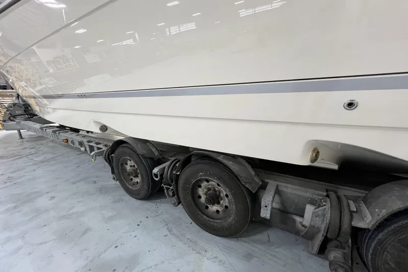  Yacht Photos Pics 2025 Scout 530 LXF boat on trailer in a warehouse setting.