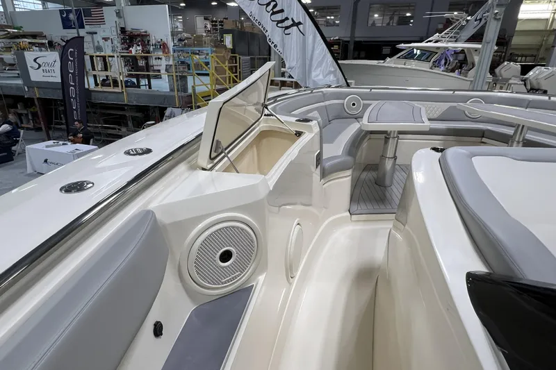  Yacht Photos Pics 2025 Scout 530 LXF boat interior with seating and storage, showcased at an indoor event.