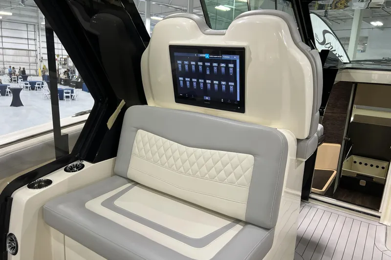  Yacht Photos Pics 2025 Scout 530 LXF boat interior with touchscreen and cushioned seating.