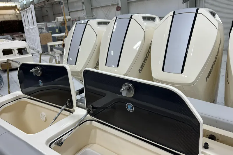  Yacht Photos Pics 2025 Scout 530 LXF boat with Mercury engines in a workshop setting.