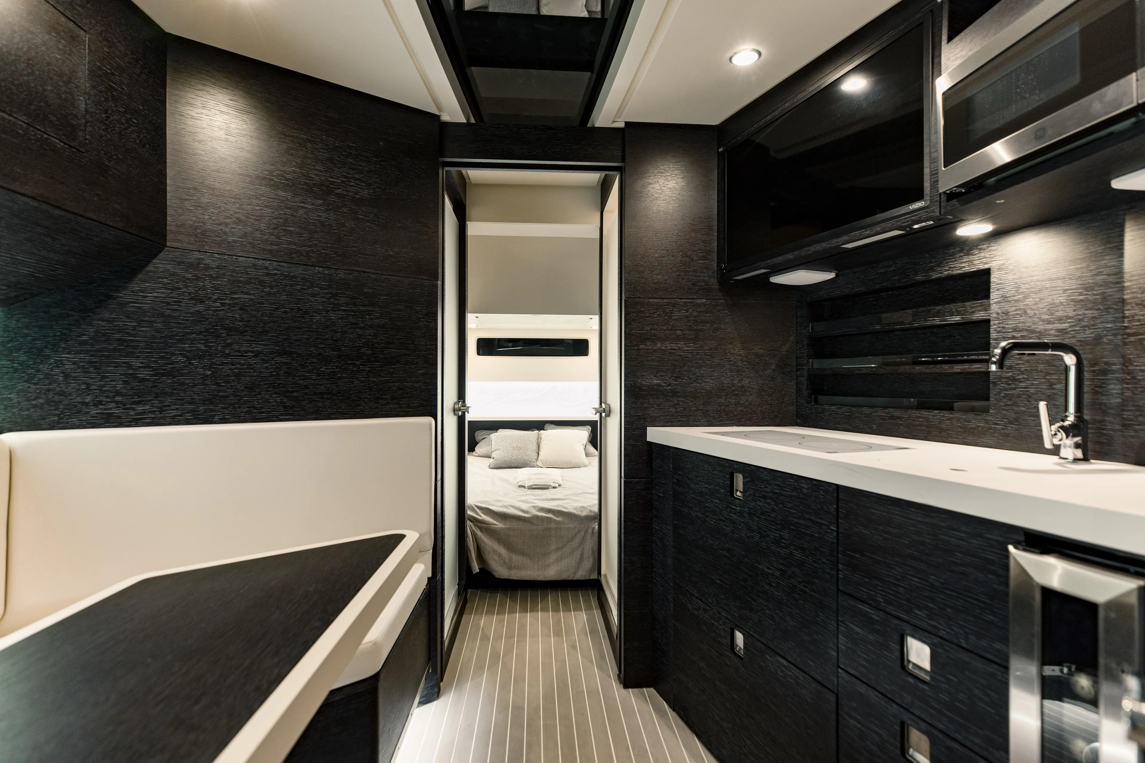  Yacht Photos Pics Luxurious interior of 2025 Scout 530 LXF yacht with modern kitchen and cozy bedroom.