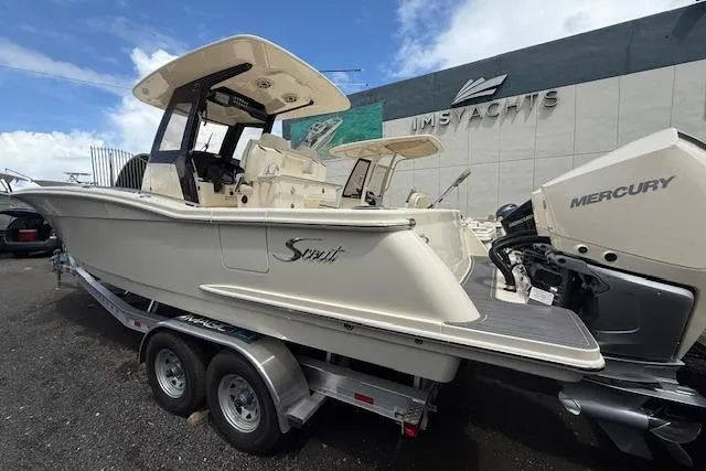  Yacht Photos Pics 2026 Scout 288 LXF boat on trailer at dealership, featuring Mercury engine.
