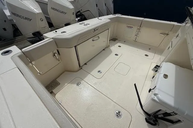  Yacht Photos Pics 2026 Scout 288 LXF boat deck with Mercury engines, featuring spacious layout and storage compartments.