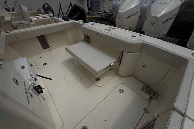  Yacht Photos Pics 2026 Scout 288 LXF boat interior with seating and Mercury engines in the background.