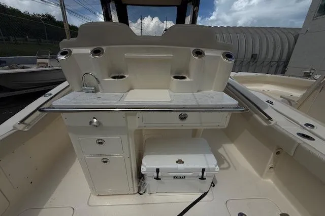  Yacht Photos Pics 2026 Scout 288 LXF boat interior with sink, storage, and cooler.