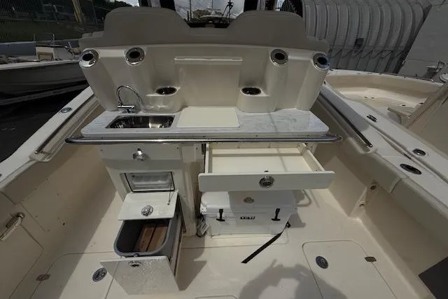  Yacht Photos Pics 2026 Scout 288 LXF boat interior with sink, storage, and cooler.