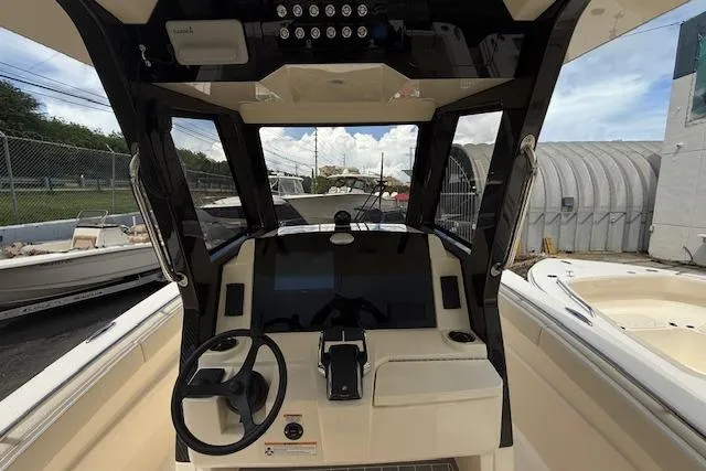  Yacht Photos Pics 2026 Scout 288 LXF boat cockpit with steering wheel and control panel.