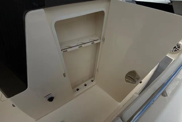  Yacht Photos Pics 2026 Scout 288 LXF boat storage compartment with open door, showcasing interior space.