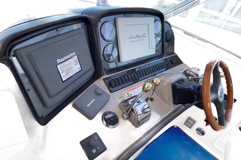  Yacht Photos Pics 2007 Sea Ray 40 Sundancer helm with Raymarine navigation system and wooden steering wheel.