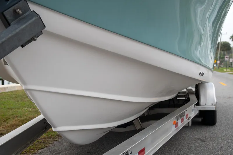 Yacht Photos Pics 2021 Tidewater 280 CC Adventure boat hull on trailer, side view.
