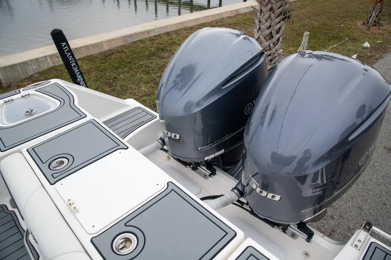  Yacht Photos Pics Twin outboard engines on a 2021 Tidewater 280 CC Adventure boat, docked by the water.
