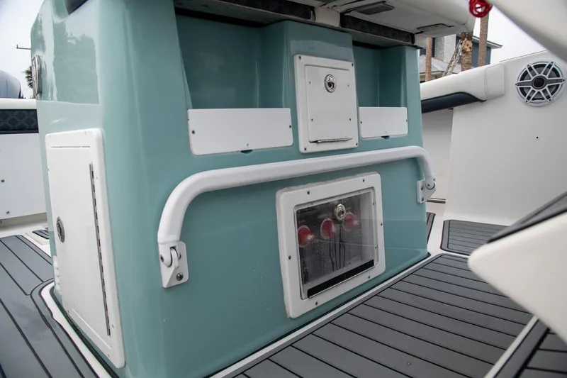  Yacht Photos Pics 2021 Tidewater 280 CC Adventure boat interior with teal console and storage compartments.