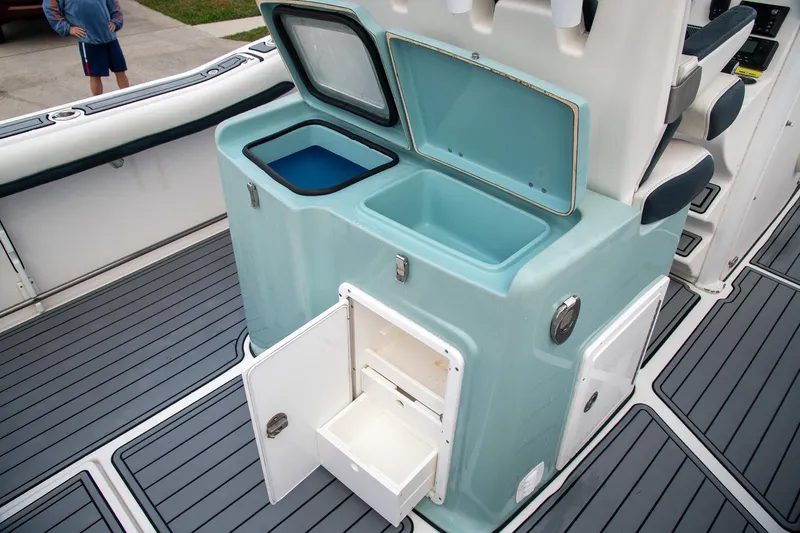  Yacht Photos Pics Tidewater 280 CC Adventure 2021 boat interior with open storage compartments and deck view.