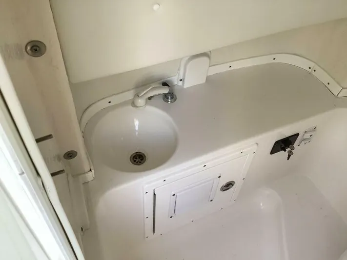  Yacht Photos Pics 2021 Tidewater 280 CC Adventure boat interior sink and storage area.