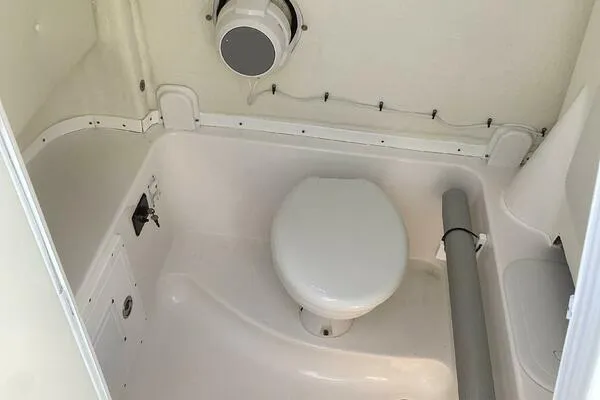  Yacht Photos Pics 2021 Tidewater 280 CC Adventure boat bathroom with white marine toilet.