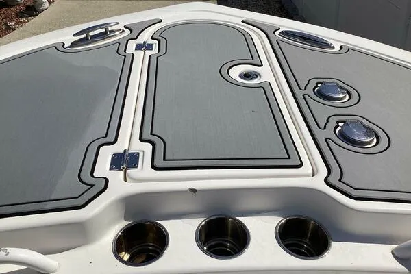 Yacht Photos Pics 2021 Tidewater 280 CC Adventure boat deck with storage compartments and cup holders.