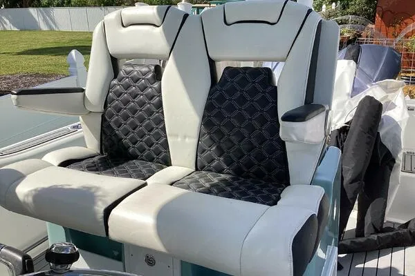  Yacht Photos Pics 2021 Tidewater 280 CC Adventure boat seats with black diamond-pattern upholstery.