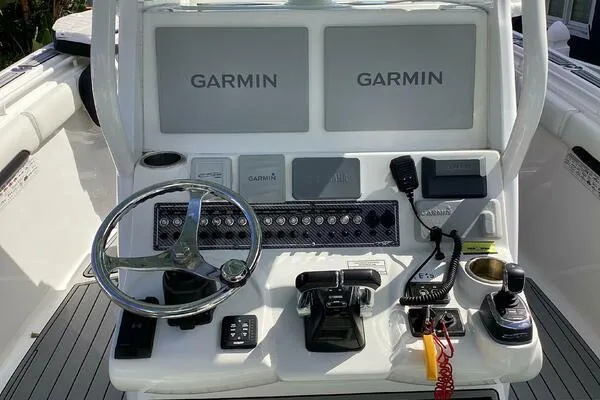  Yacht Photos Pics 2021 Tidewater 280 CC Adventure boat console with Garmin displays and steering wheel.