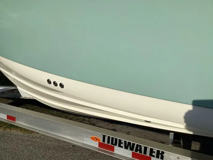  Yacht Photos Pics 2021 Tidewater 280 CC Adventure boat on trailer, showcasing sleek hull design.