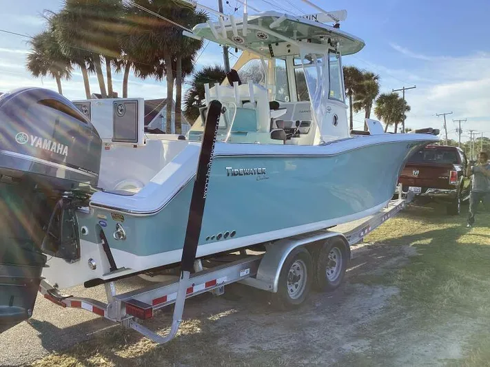  Yacht Photos Pics 2021 Tidewater 280 CC Adventure boat on trailer, parked outdoors with palm trees.