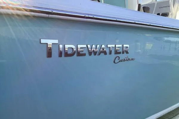  Yacht Photos Pics 2021 Tidewater 280 CC Adventure boat with custom lettering in sunlight.