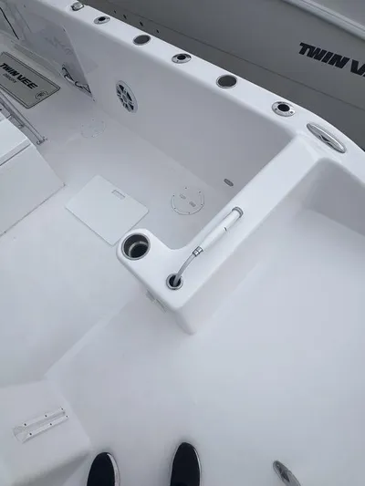  Yacht Photos Pics 2024 Twin Vee 280 STX boat deck with rod holders and storage compartments.