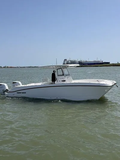  Yacht Photos Pics 2024 Twin Vee 280 STX boat on calm water, clear sky background.