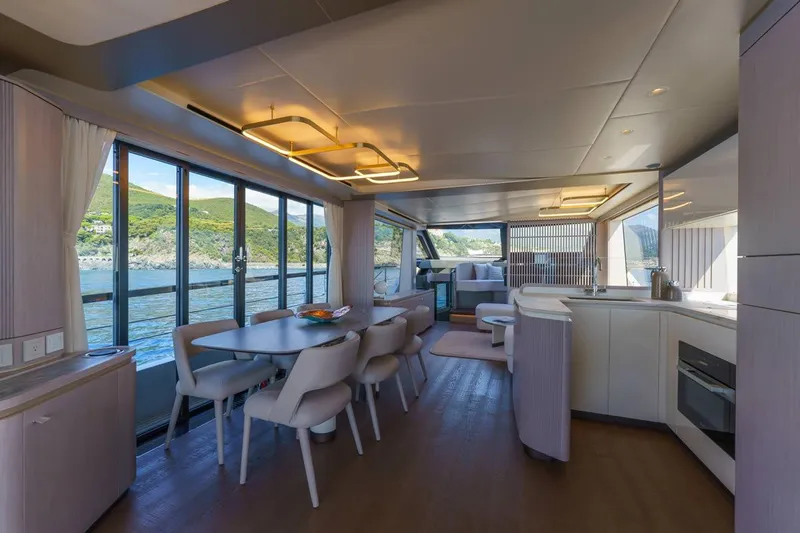  Yacht Photos Pics Luxurious interior of 2026 Absolute 70 Fly yacht with modern dining and kitchen area.