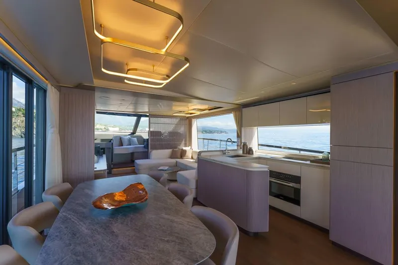  Yacht Photos Pics Luxurious interior of 2026 Absolute 70 Fly yacht with modern kitchen and dining area.