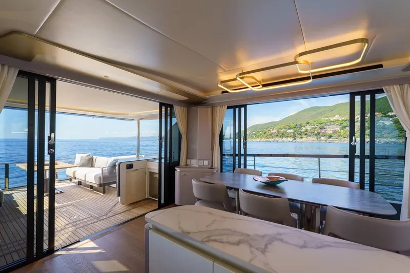  Yacht Photos Pics Luxurious interior of 2026 Absolute 70 Fly yacht with ocean view and elegant dining area.