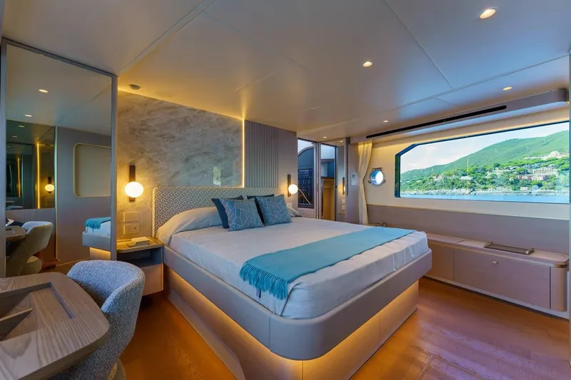  Yacht Photos Pics Luxurious bedroom interior of 2026 Absolute 70 Fly yacht with scenic ocean view.
