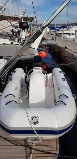  Yacht Photos Pics Inflatable boat docked beside a 2004 Uniesse 57 yacht in a marina.