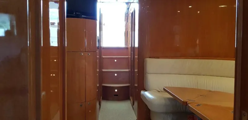  Yacht Photos Pics Interior of 2004 Uniesse 57 yacht with wooden cabinetry and beige seating.