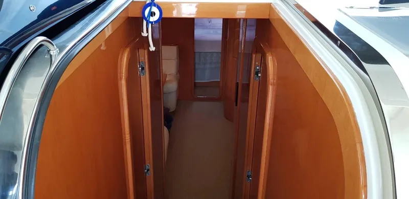  Yacht Photos Pics Interior view of 2004 Uniesse 57 yacht with wooden finish and keys hanging.