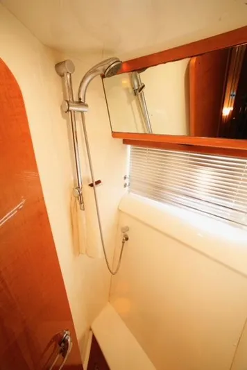  Yacht Photos Pics Shower area in a 2004 Uniesse 57 yacht, featuring modern fixtures and a large mirror.